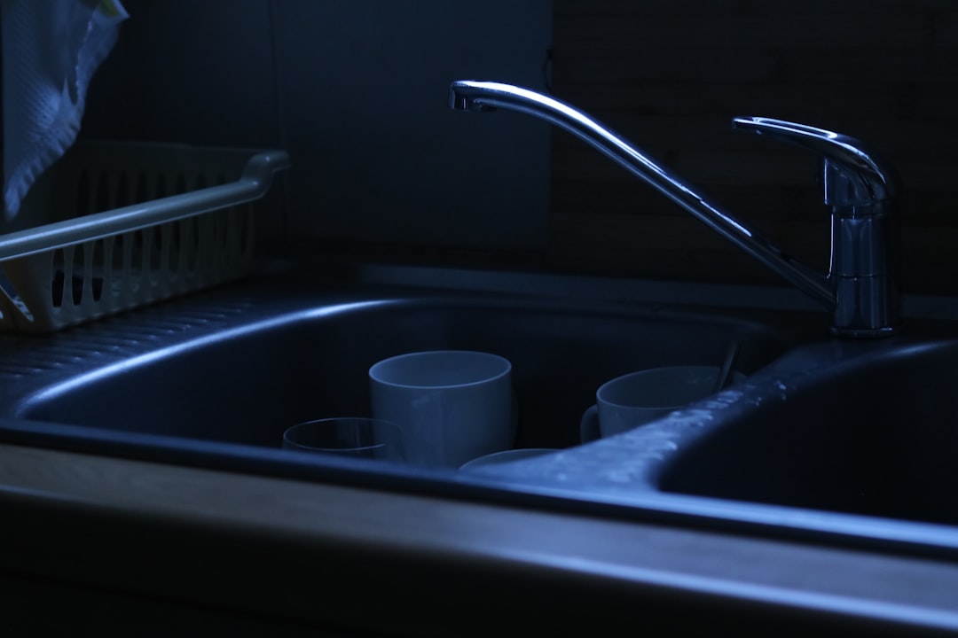 Dirty dishes in a dark kitchen sink