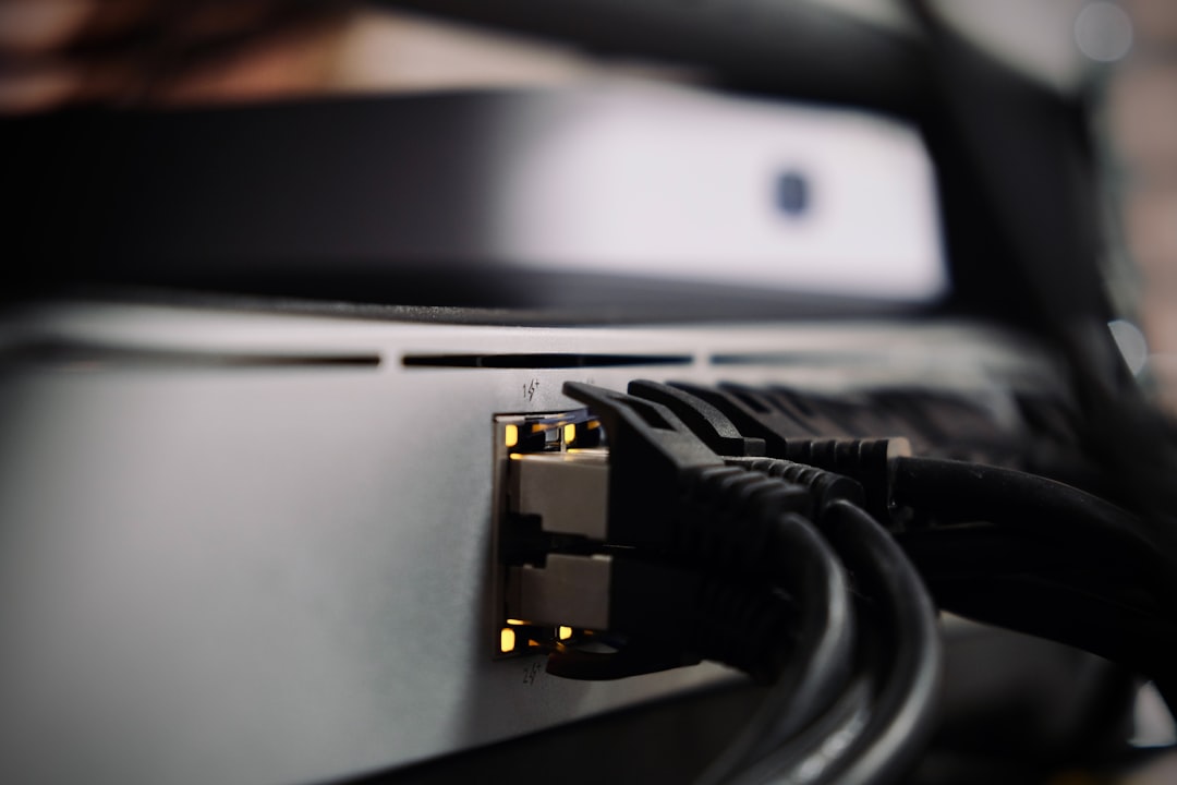 Ethernet cables connected to the back of a network device.