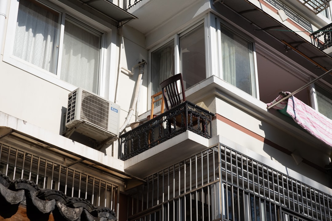 Air conditioner unit mounted on a building exterior.