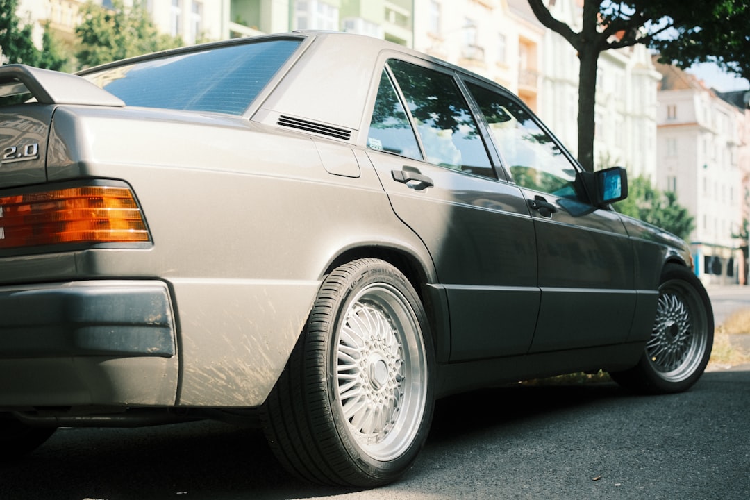 A classic mercedes-benz car is parked on the street.