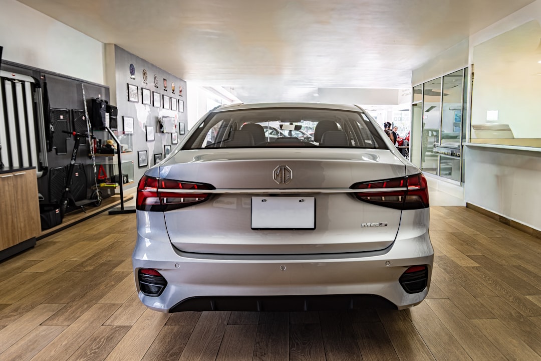 Rear view of a silver sedan in a showroom.