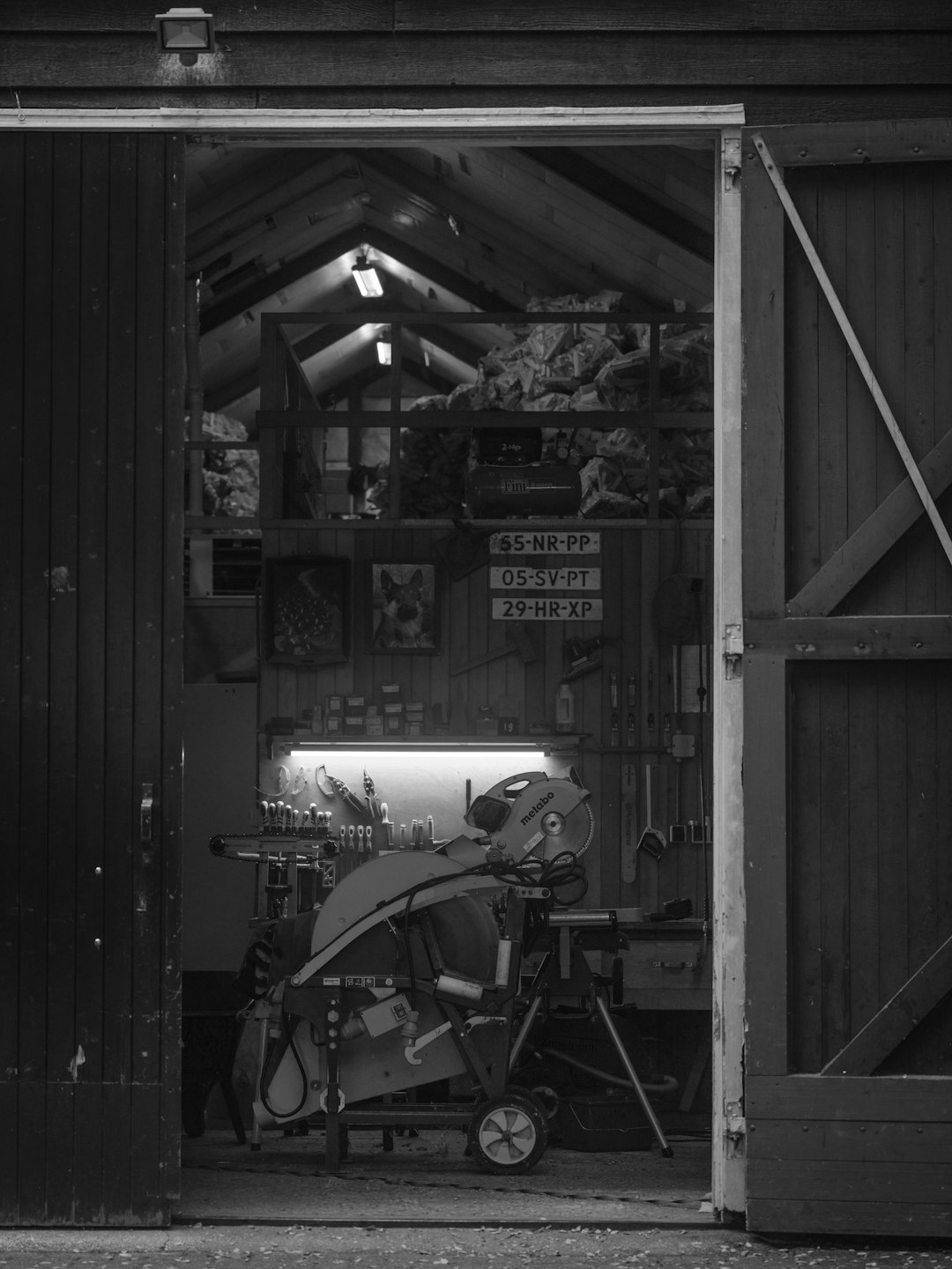 Interior of a cluttered workshop with tools and equipment.