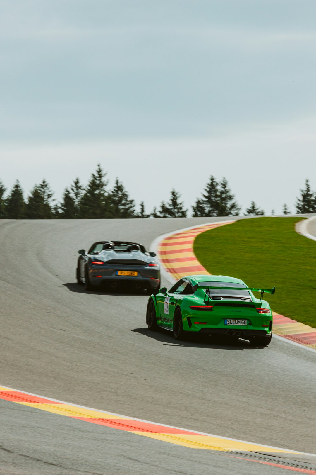 Two sports cars racing on a track