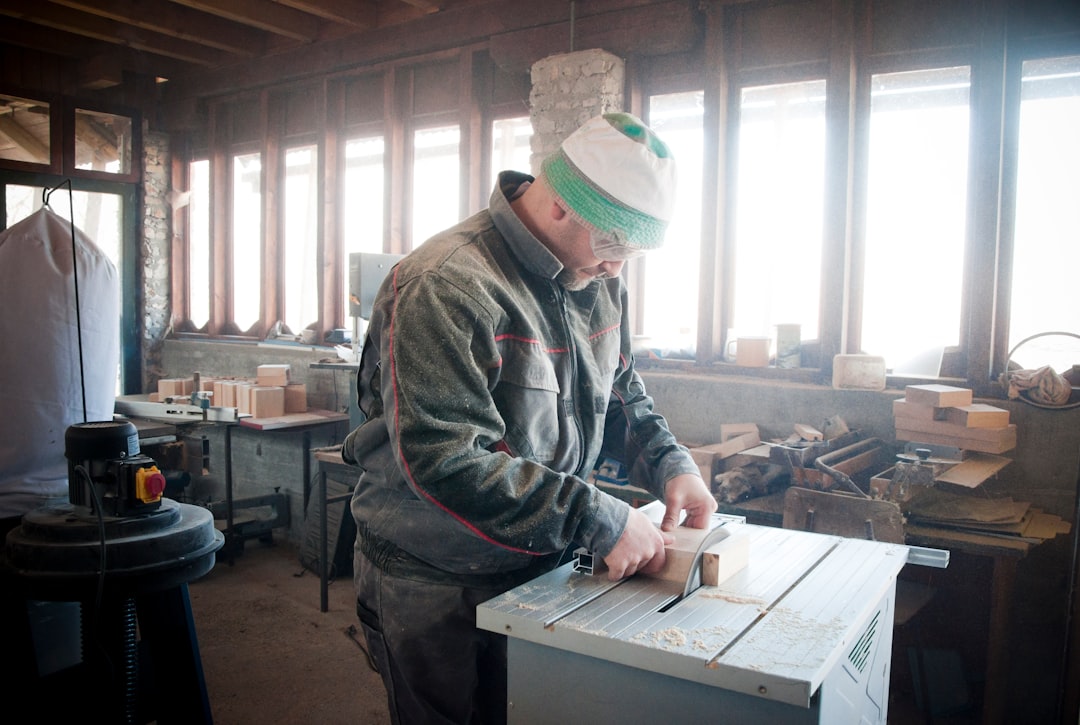 unknown person using table saw indoors