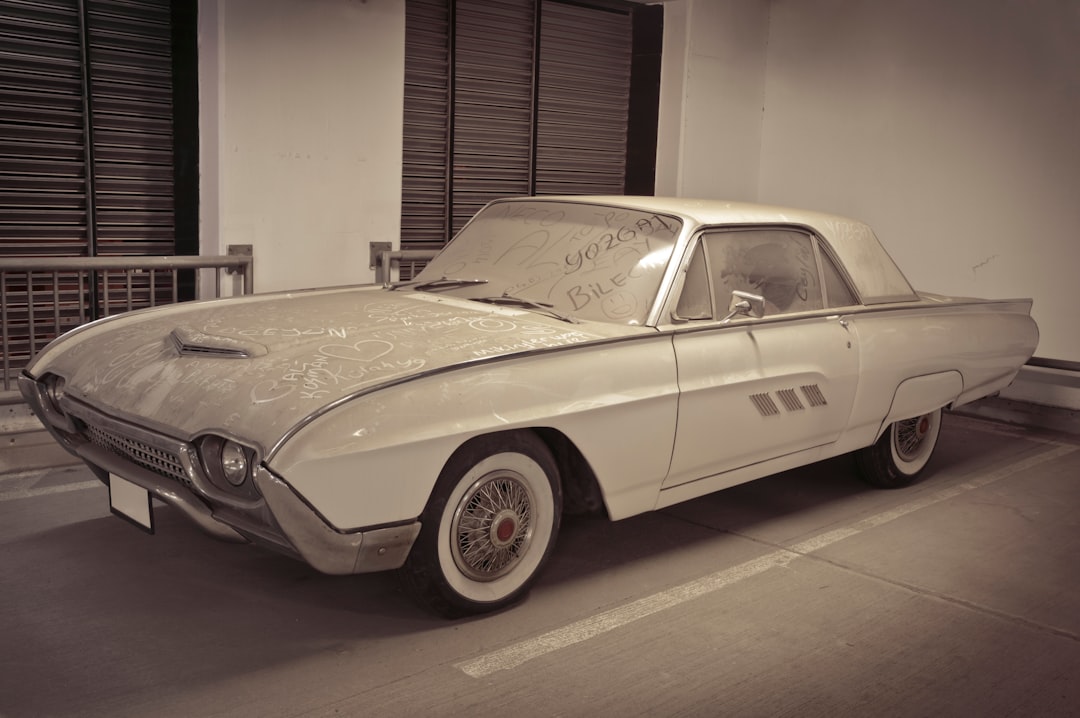Dusty classic white car parked indoors