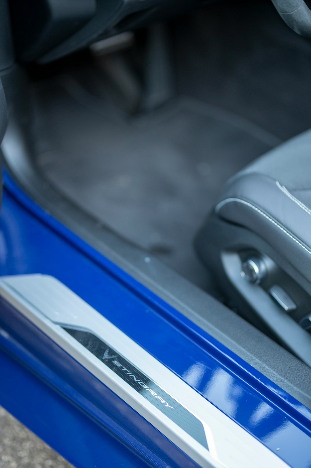Close-up of a blue car interior with stingray emblem