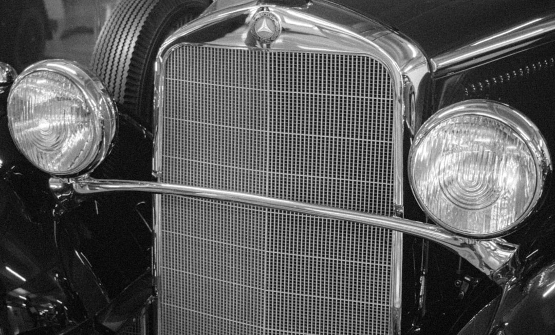 Close-up of a vintage car's grille and headlights