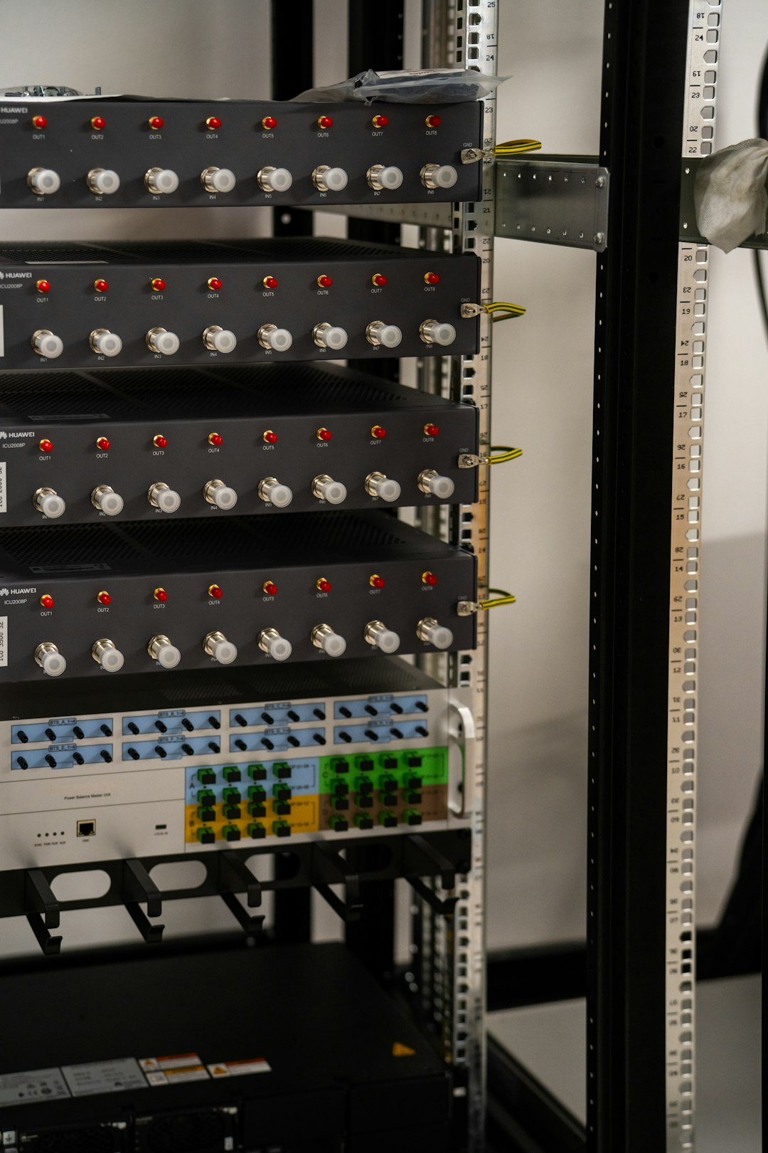 Server rack filled with network and electronic equipment.