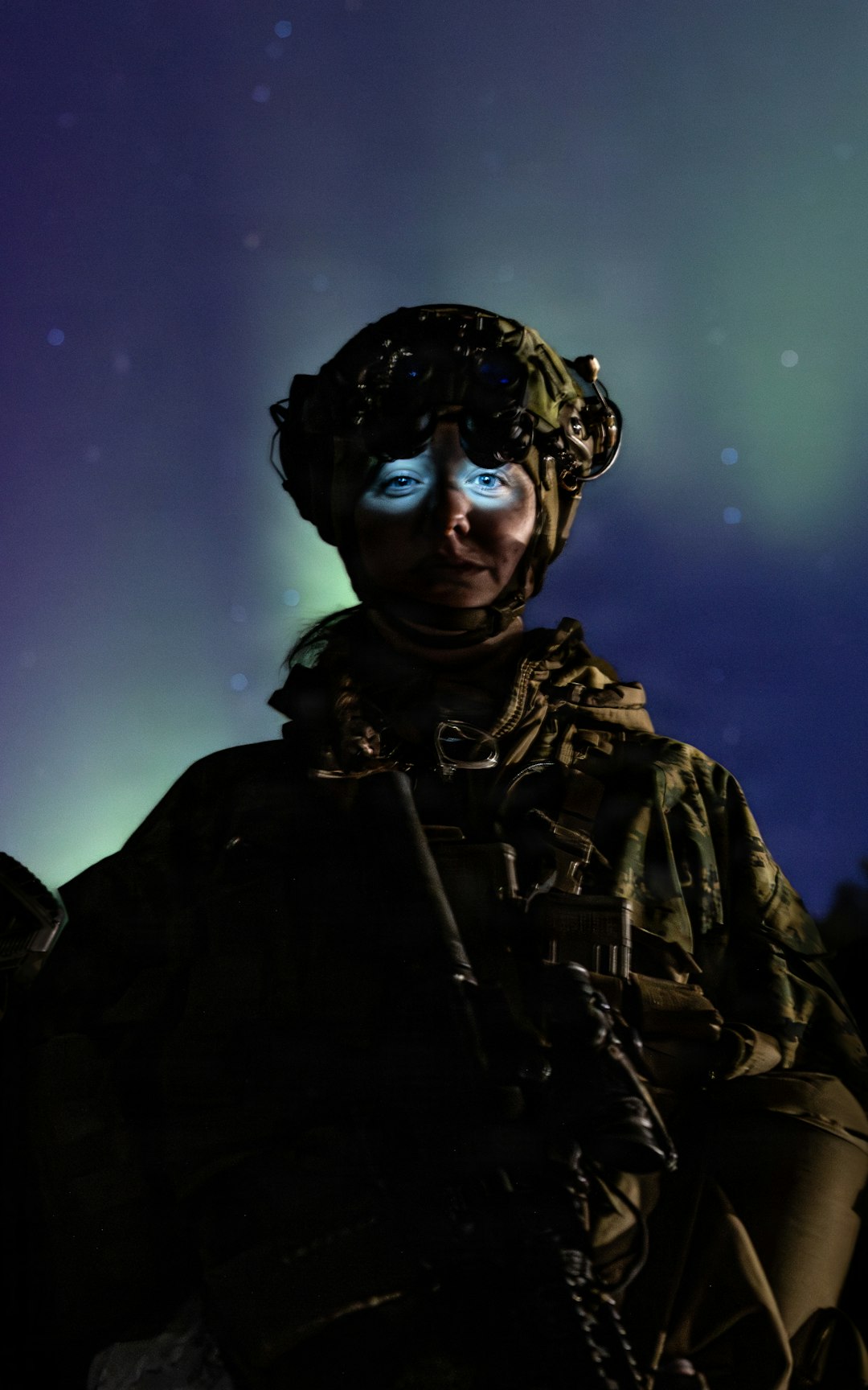Soldier with glowing eyes under the aurora borealis.