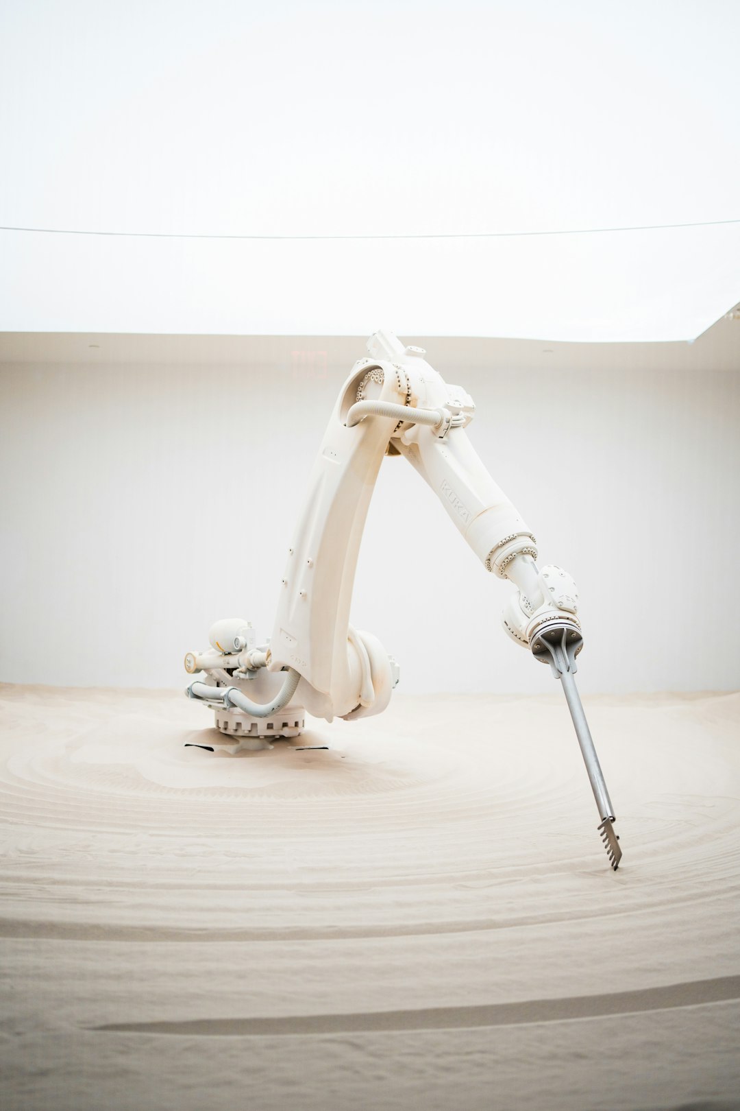 A robotic arm holding a screwdriver on top of a table