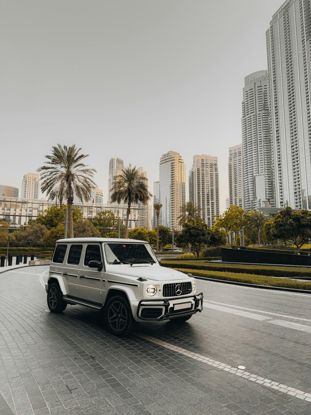 Silver luxury suv driving on a city street.