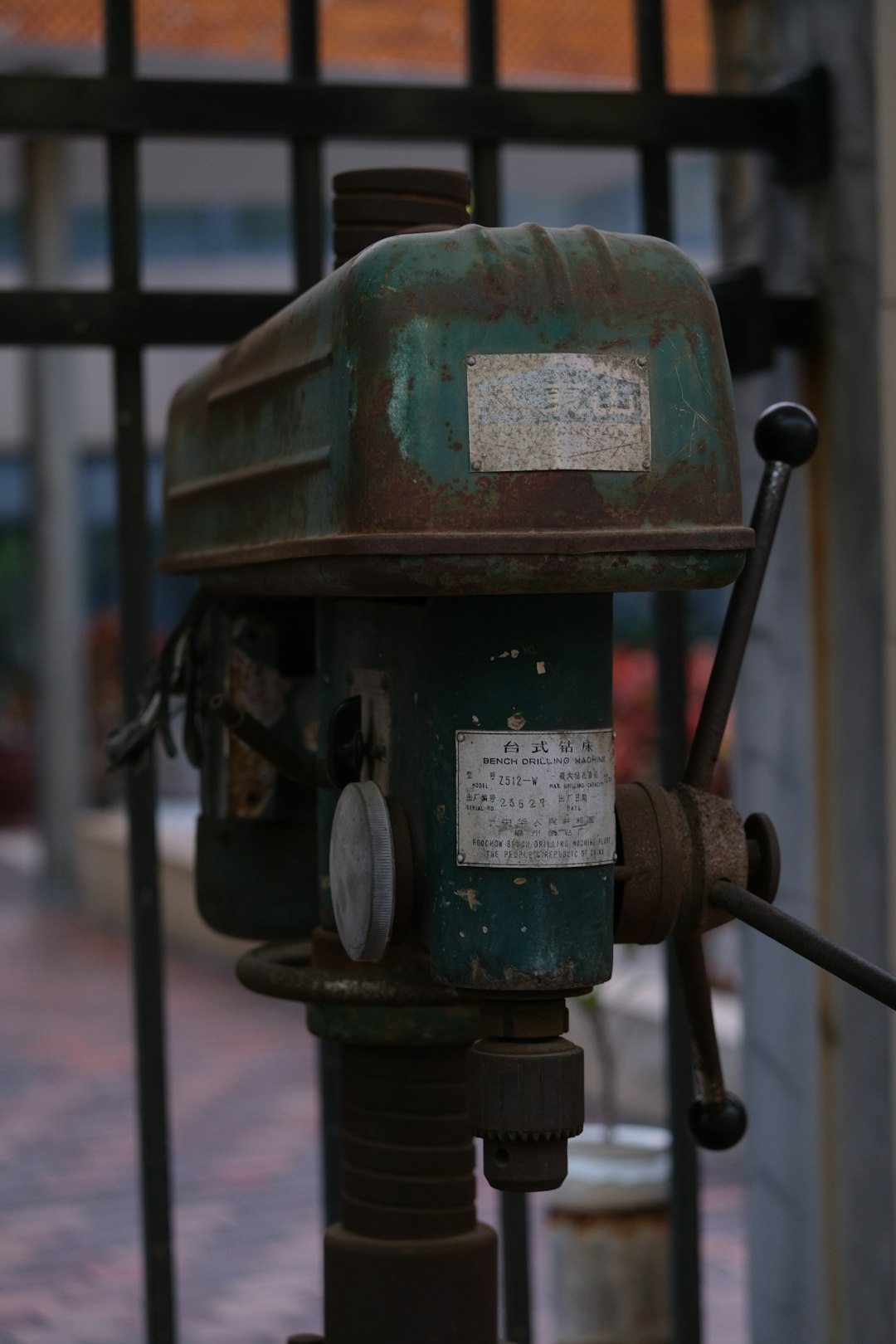 Rusty old drill press with labels