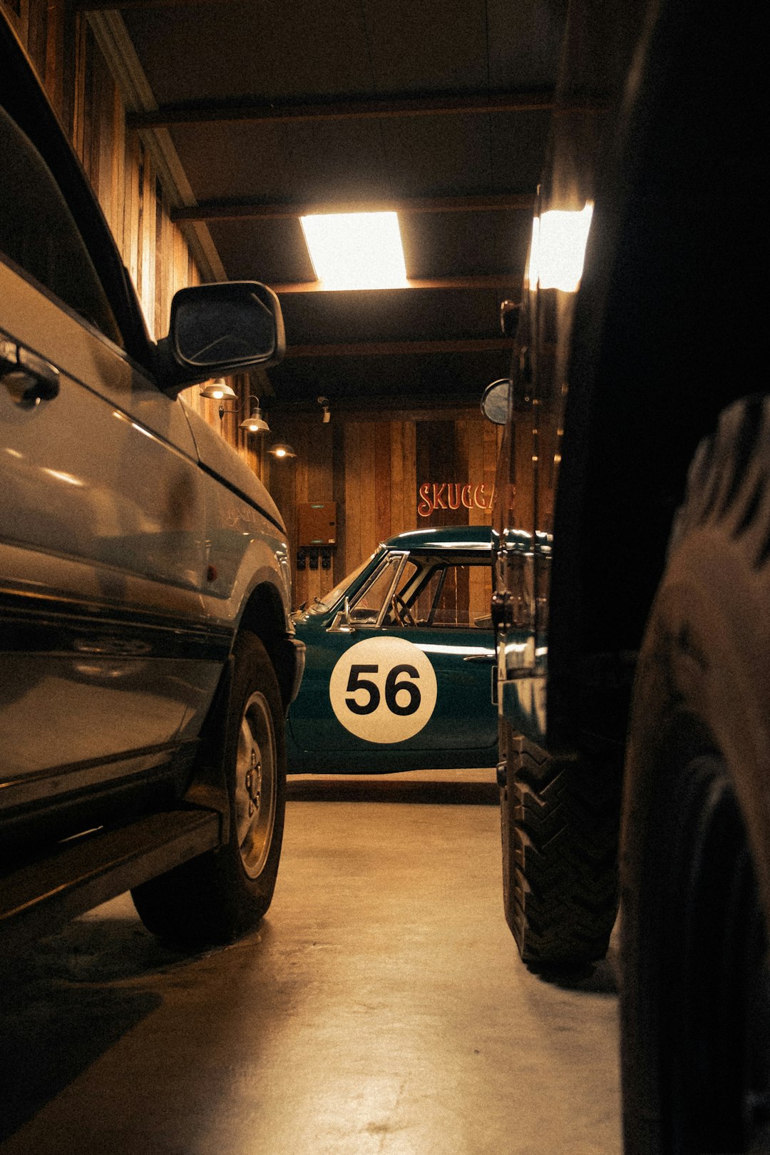 Classic race car parked in a dimly lit garage.