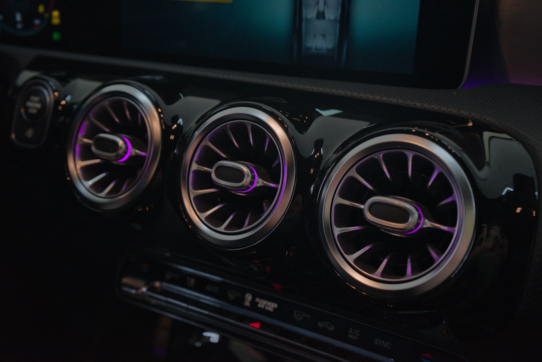 Close-up of car air vents with ambient lighting.