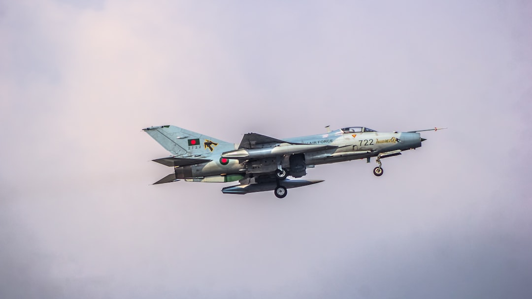 A fighter jet flying through a cloudy sky