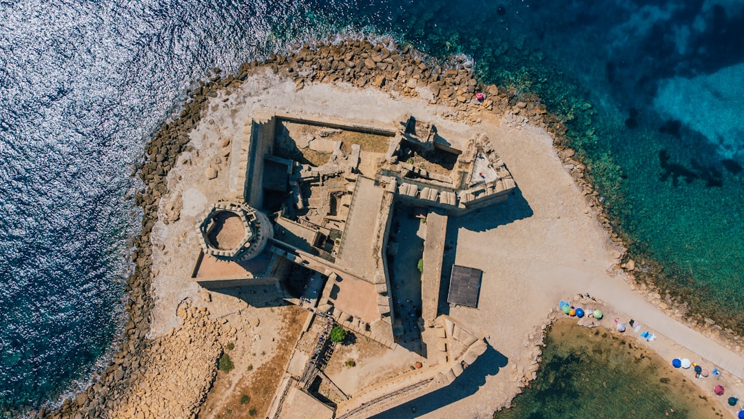 an aerial view of a castle in the ocean