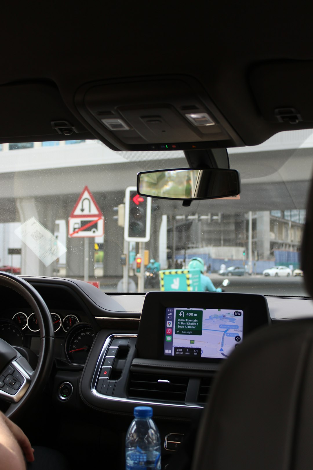 Car interior with navigation screen and traffic lights