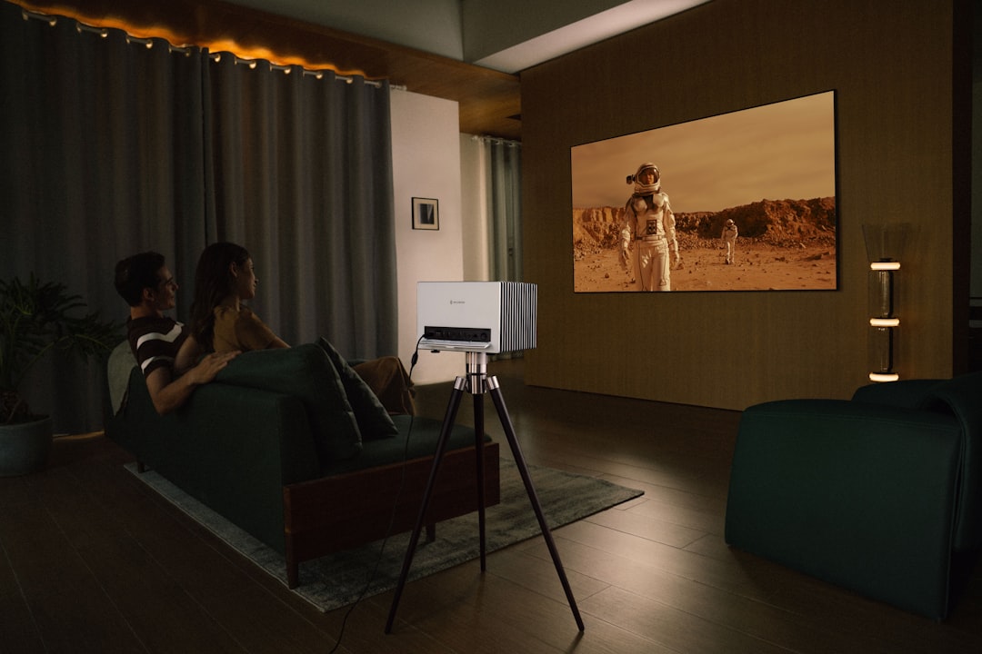 Couple watches movie projected onto wall