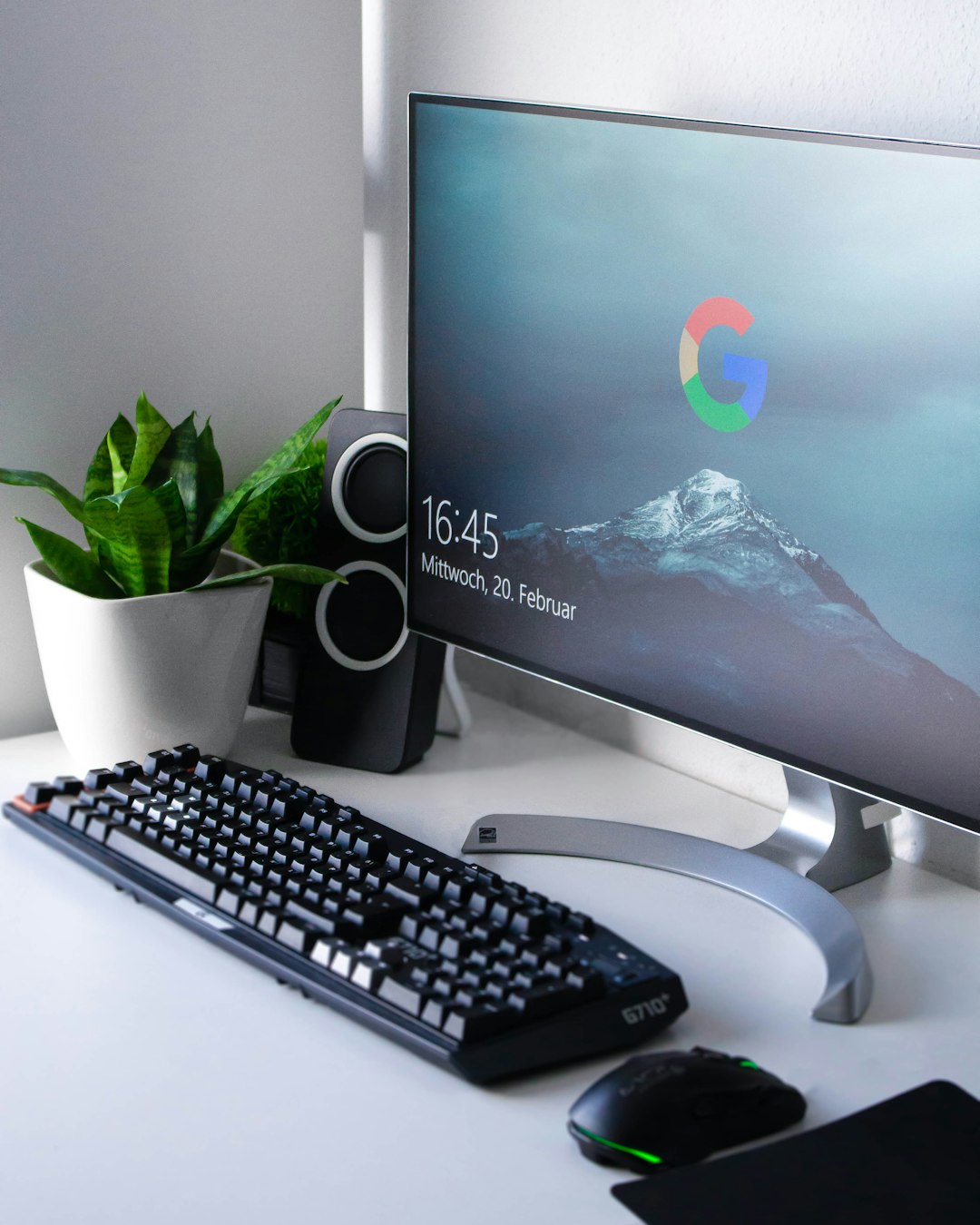 black Logitech G710 wireless keyboard and wireless mouse near gray flat screen computer monitor on table