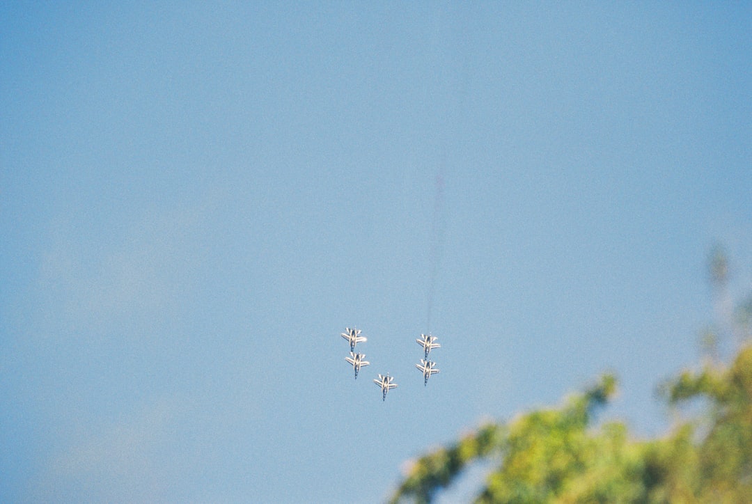 Four jets flying in formation with smoke trails