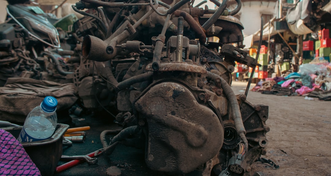 Close-up of a rusty engine with a water bottle