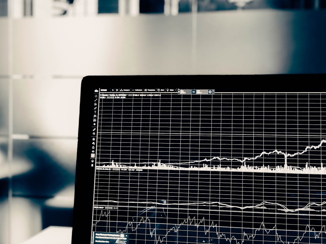 A computer screen displaying a white line graph of financial market data