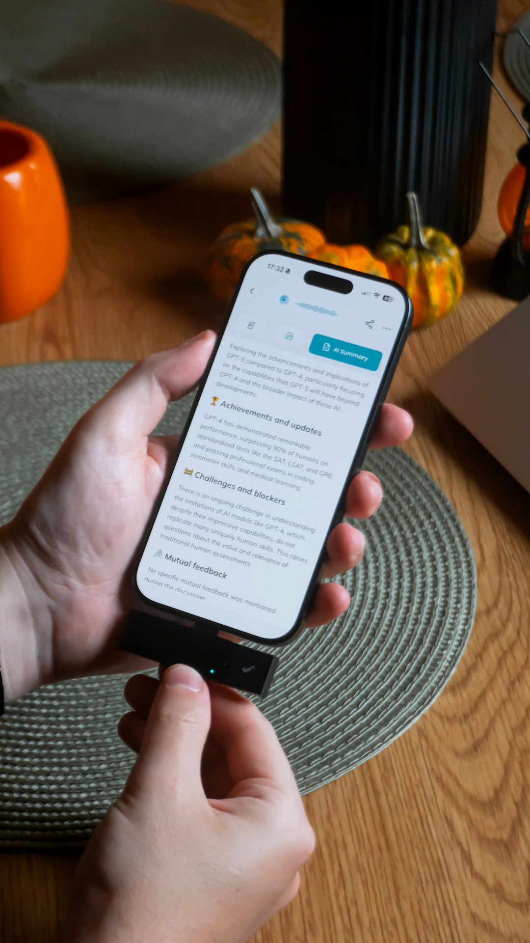 Hands holding a smartphone connected to a usb drive