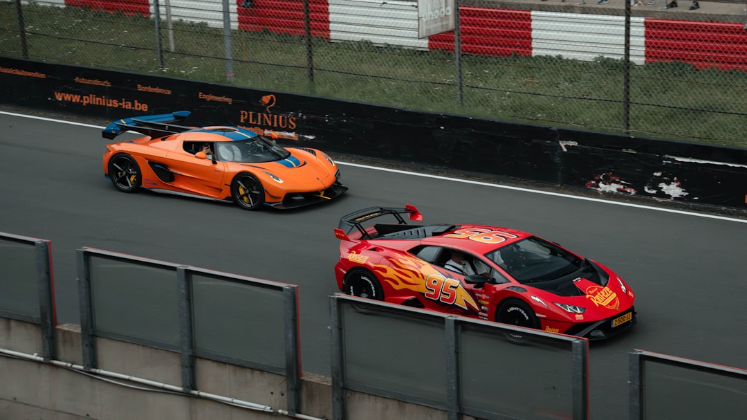 Orange and red sports cars on a race track
