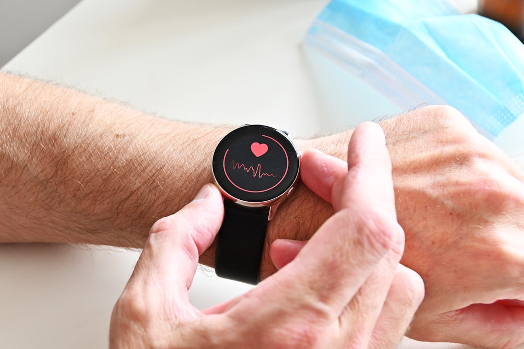 A person checking a heart rate monitor on a smartwatch on their wrist