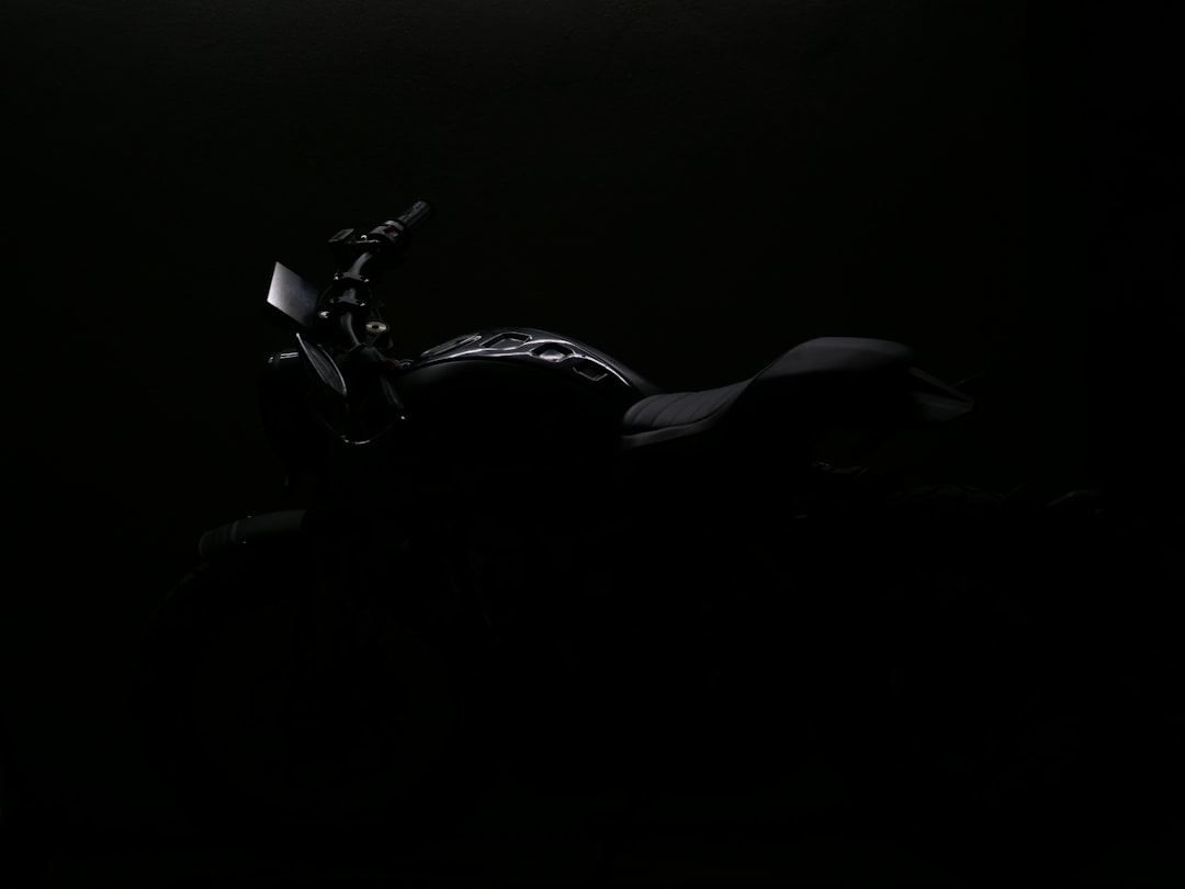 a motorcycle is shown in the dark with its headlights on