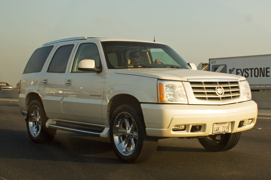 White cadillac escalade driving on a highway