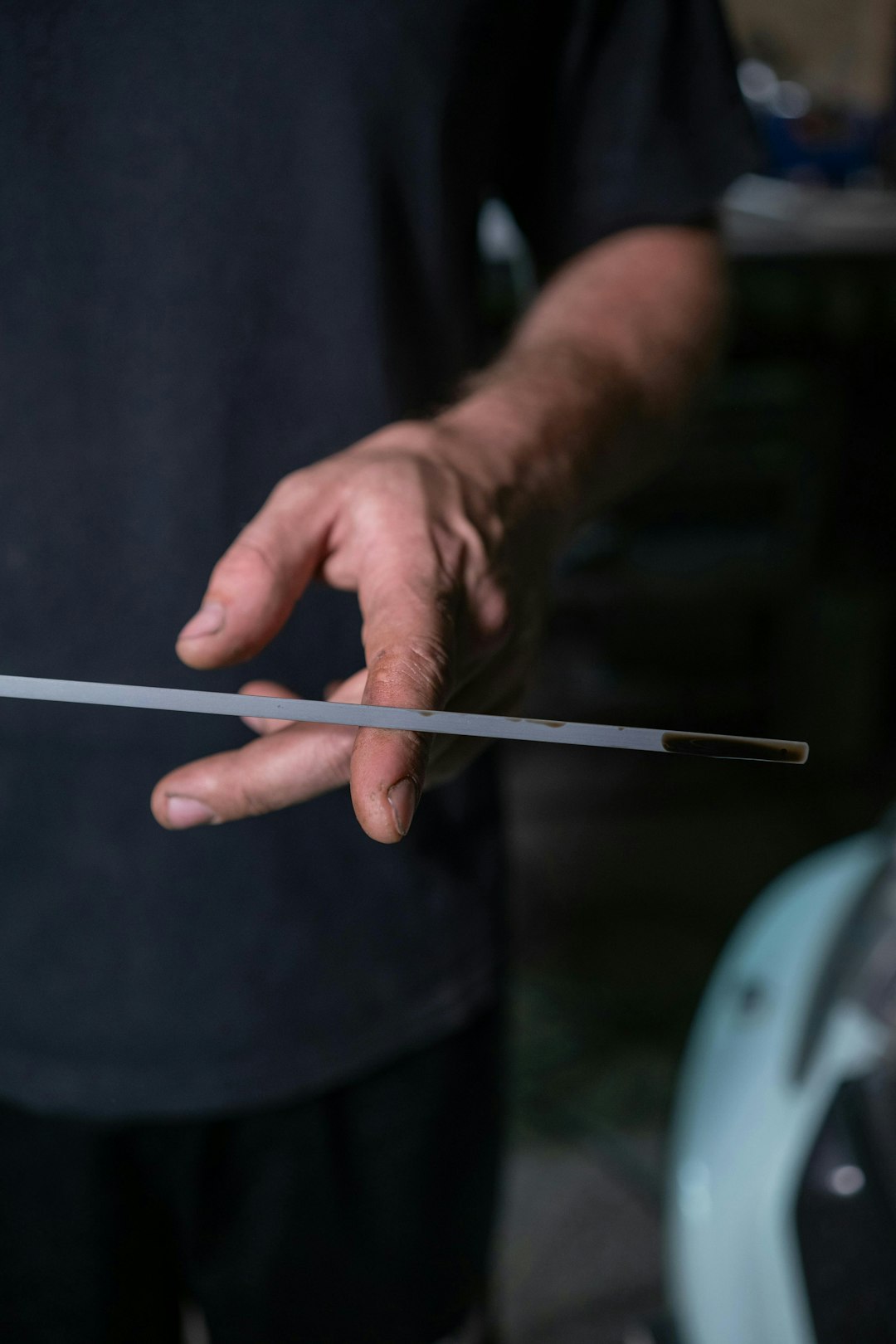 Man checking car oil with dipstick