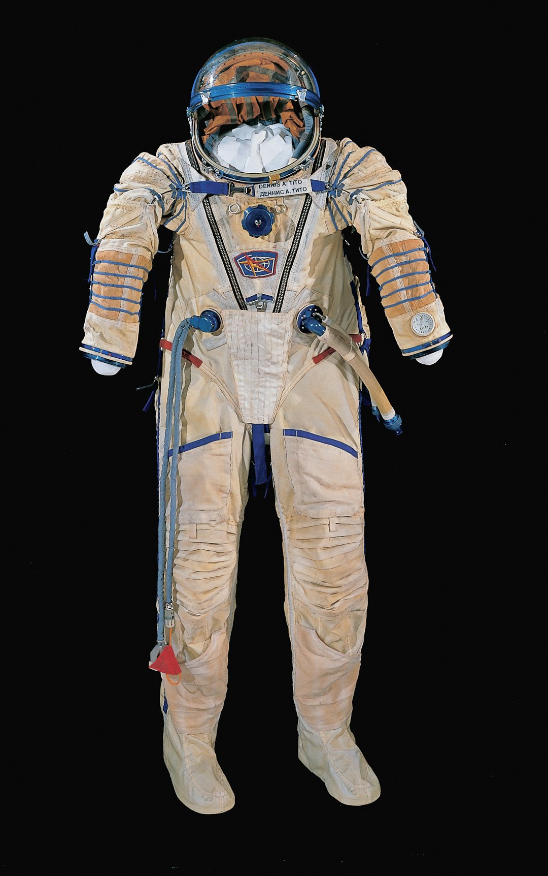 Cream-colored astronaut spacesuit with blue details on black