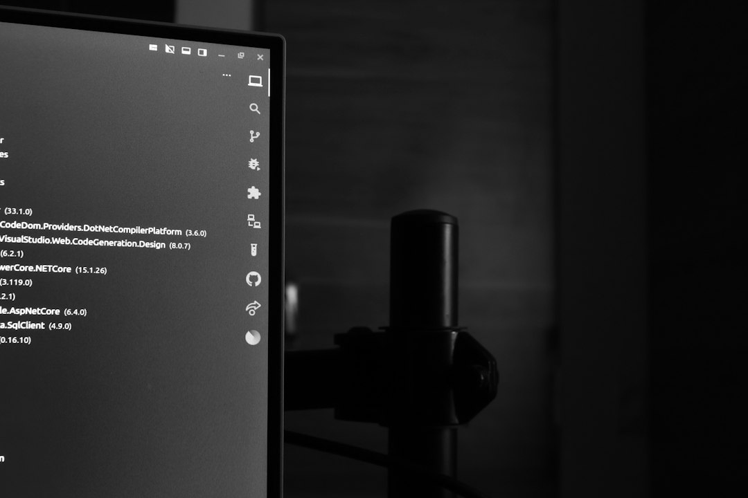 Computer monitor displaying code in a dark room
