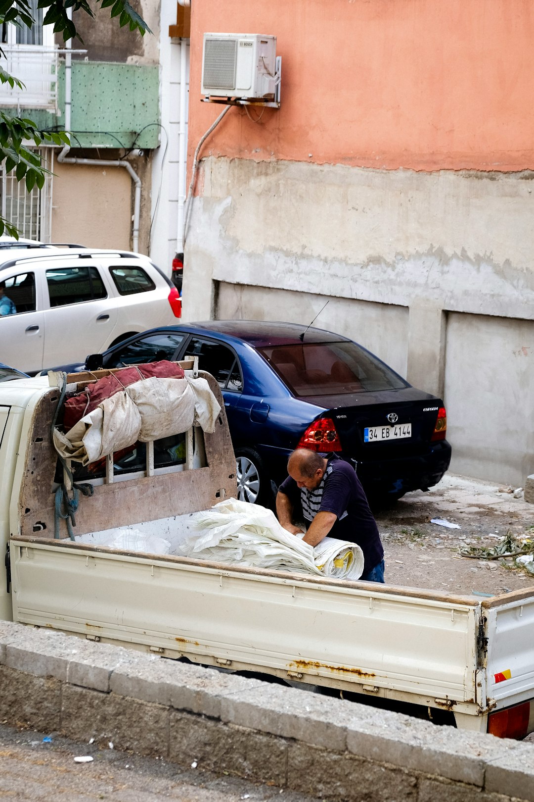 a person in a red hat and a red hat looking at a car that has been in a