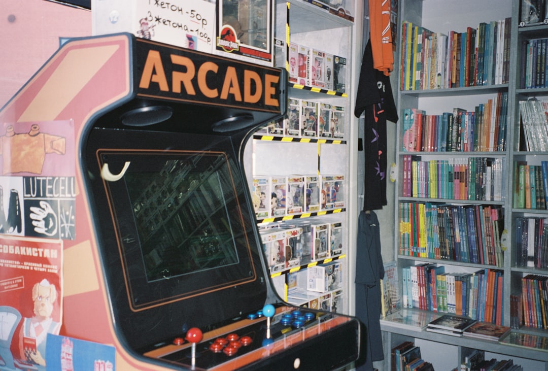 An arcade machine in front of a bookshelf
