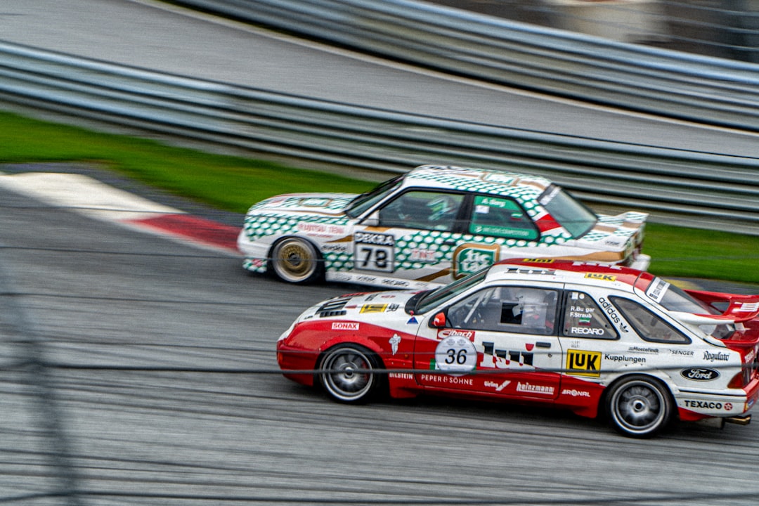 A couple of cars racing on a race track
