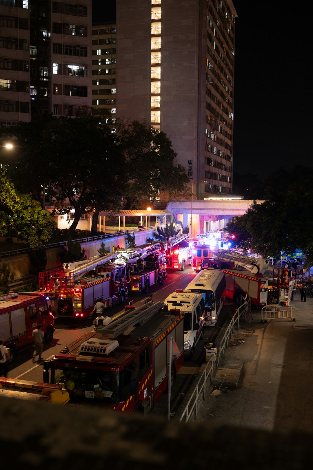 Fire trucks and emergency vehicles at night scene